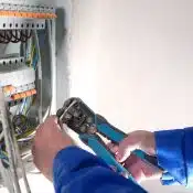 What are some risks associated with hiring an unlicensed electrician